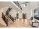 Bright and airy entryway features hardwood floors, modern staircase, and large format art at 3534 Running Deer Dr, Castle Rock, CO 80109