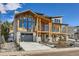 Modern farmhouse style home with wood siding, stone accents and a three-car garage at 3534 Running Deer Dr, Castle Rock, CO 80109