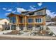 Stunning two-story home with stone and wood accents, a landscaped yard, and a large driveway at 3534 Running Deer Dr, Castle Rock, CO 80109