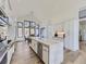 Gourmet kitchen with white cabinets, large island, stainless steel appliances, and a spacious layout at 3534 Running Deer Dr, Castle Rock, CO 80109