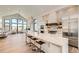 Modern kitchen with white cabinetry, large island, stainless steel appliances, and marble countertops at 3534 Running Deer Dr, Castle Rock, CO 80109