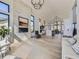 Open concept living space with hardwood floors, a fireplace, and views into the kitchen area at 3534 Running Deer Dr, Castle Rock, CO 80109