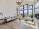 Spacious living room with hardwood floors, fireplace, and wall of windows providing natural light at 3534 Running Deer Dr, Castle Rock, CO 80109