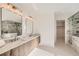 Modern bathroom featuring dual vanities, a walk-in shower, and stylish fixtures at 3534 Running Deer Dr, Castle Rock, CO 80109