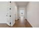 Bright hallway with hardwood floors and access to other rooms at 1136 Hillside Ln, Louisville, CO 80027