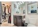 Full bathroom with walk-in closet, toilet, and dark vanity at 249 S Old Hammer St, Aurora, CO 80018