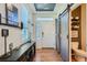 Bright and spacious entryway with barn door to powder room and console table at 249 S Old Hammer St, Aurora, CO 80018