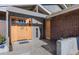 Inviting front entrance with a wood door and brick facade at 4557 Tanglewood Trl, Boulder, CO 80301