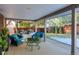 Relaxing covered patio with comfortable seating and a glass top table at 4557 Tanglewood Trl, Boulder, CO 80301