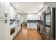 Modern kitchen with stainless steel appliances and hardwood floors at 9572 Desert Willow Way, Highlands Ranch, CO 80129