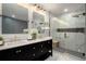 Spa-like bathroom with double vanity, large walk-in shower, and marble finishes at 343 Elati St, Denver, CO 80223