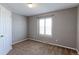Simple bedroom with neutral walls, carpet flooring and window shutters at 41321 E 88Th Ave, Bennett, CO 80102