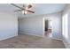 Bright bedroom with carpet flooring, ceiling fan, and access to a full bathroom at 41321 E 88Th Ave, Bennett, CO 80102
