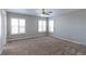 Spacious bedroom with neutral walls and carpet, featuring a ceiling fan and window shutters at 41321 E 88Th Ave, Bennett, CO 80102