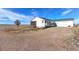 Ranch-style home with a gravel driveway, screened porch, and attached garage at 41321 E 88Th Ave, Bennett, CO 80102