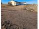 Ranch style home with gravel driveway and spacious yard at 41321 E 88Th Ave, Bennett, CO 80102