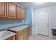 Laundry room with wooden cabinets, a utility sink, and built-in shelving at 41321 E 88Th Ave, Bennett, CO 80102