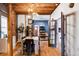 Bright dining area with exposed beams, brick wall, and modern table at 2731 California St, Denver, CO 80205