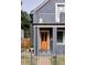 Gray house with a wood front door and small porch at 2731 California St, Denver, CO 80205