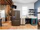 Updated kitchen with stainless steel appliances and exposed brick wall at 2731 California St, Denver, CO 80205