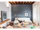 Modern living room with comfy couch and exposed beams at 2731 California St, Denver, CO 80205