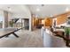 Basement recreation area featuring ping pong table, seating, and access to the backyard at 16655 W 93Rd Pl, Arvada, CO 80007