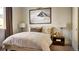 Cozy bedroom with neutral decor and a mountain-themed artwork at 16655 W 93Rd Pl, Arvada, CO 80007