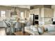 Modern kitchen featuring an island with bar seating, quartz countertops, stainless appliances, pendant lighting at 16655 W 93Rd Pl, Arvada, CO 80007