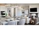 Open-concept kitchen and living room with a large island, fireplace, and modern decor at 16655 W 93Rd Pl, Arvada, CO 80007
