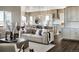 Cozy living area adjacent to the kitchen featuring a fireplace, large windows, and balcony access at 16655 W 93Rd Pl, Arvada, CO 80007