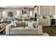 Open concept living area with a neutral sofa, a rug, and access to the kitchen at 16655 W 93Rd Pl, Arvada, CO 80007