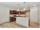 Modern kitchen featuring island, stainless steel appliances, and dark wood cabinetry at 323 Josef Cir, Fort Lupton, CO 80621