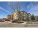 Exterior view of a multi-unit residential building with parking and landscaping at 9142 Lodestar Ln # 207, Parker, CO 80134