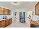 Well-equipped kitchen with wood cabinets, stainless steel appliances, and access to hallway at 2854 Eliot St, Denver, CO 80211