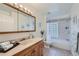 Clean bathroom featuring a bathtub, shower, and updated vanity at 2854 Eliot St, Denver, CO 80211