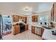Updated kitchen with wood cabinets, stainless steel appliances, and a view of the dining area at 2854 Eliot St, Denver, CO 80211