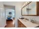 Bathroom with a vanity, a bathtub, and a glass block window at 2854 Eliot St, Denver, CO 80211