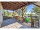 Relaxing covered back deck with access to a grassy backyard and view of trees at 2854 Eliot St, Denver, CO 80211