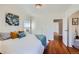 Bright bedroom with hardwood floors and access to the hallway and bathroom at 2854 Eliot St, Denver, CO 80211
