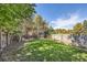 Large backyard with grassy lawn, wooden fence, and patio at 2854 Eliot St, Denver, CO 80211