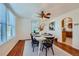 Charming dining room with hardwood floors and a table set for four, offering an open view of the kitchen at 2854 Eliot St, Denver, CO 80211