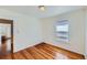 Bright bedroom with hardwood floors and an adjacent bathroom at 2854 Eliot St, Denver, CO 80211