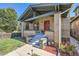 Brick home with a covered porch, steps, and landscaping at 2854 Eliot St, Denver, CO 80211