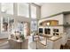 Bright living room featuring a fireplace and large windows at 30176 E 166Th Ave, Brighton, CO 80603