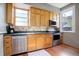Kitchen features wood cabinets, stainless steel appliances, and a tiled backsplash at 209 10Th Ave, Idaho Springs, CO 80452