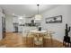 Dining area with a white table and wicker chairs, adjacent to a modern kitchen at 7040 S Clermont St, Centennial, CO 80122