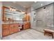 Luxurious bathroom with double vanity, large shower, and granite counters at 934 S Perry Park Rd, Sedalia, CO 80135
