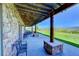 Covered patio with stone flooring, wrought iron furniture, and mountain views at 934 S Perry Park Rd, Sedalia, CO 80135