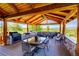 Covered patio features an outdoor kitchen with a grill and dining area at 934 S Perry Park Rd, Sedalia, CO 80135