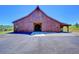 Large barn with double doors and a covered area at 934 S Perry Park Rd, Sedalia, CO 80135